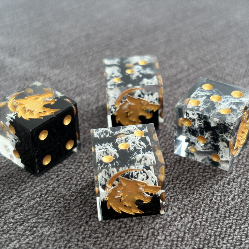 Four mountain dice arranged against a grey surface