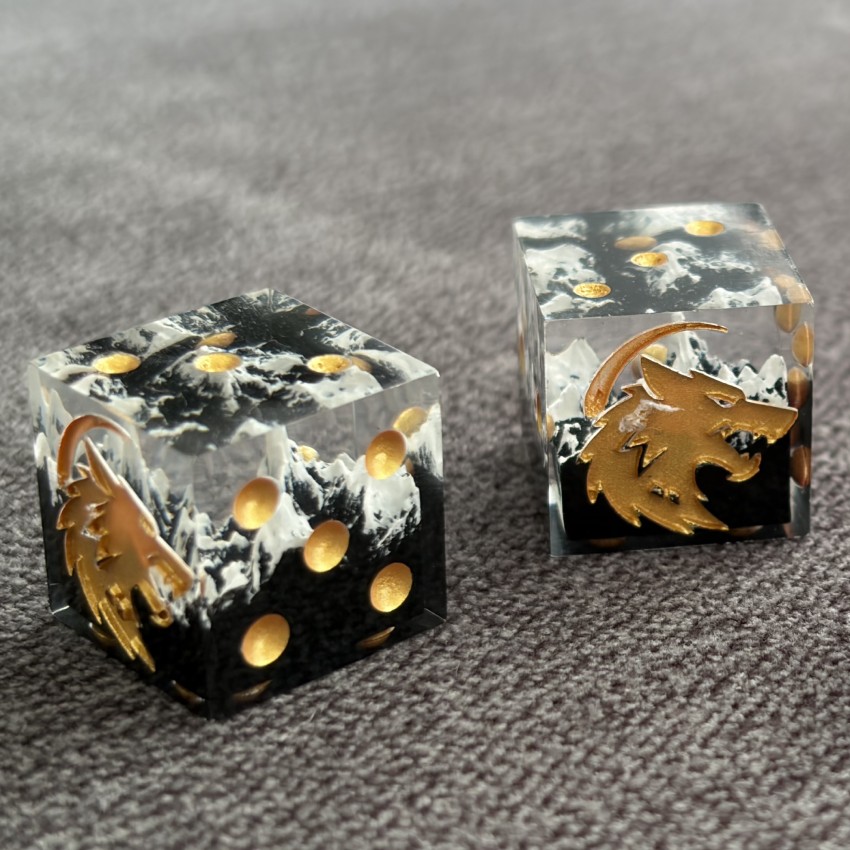 Two mountain dice arranged against a grey surface
